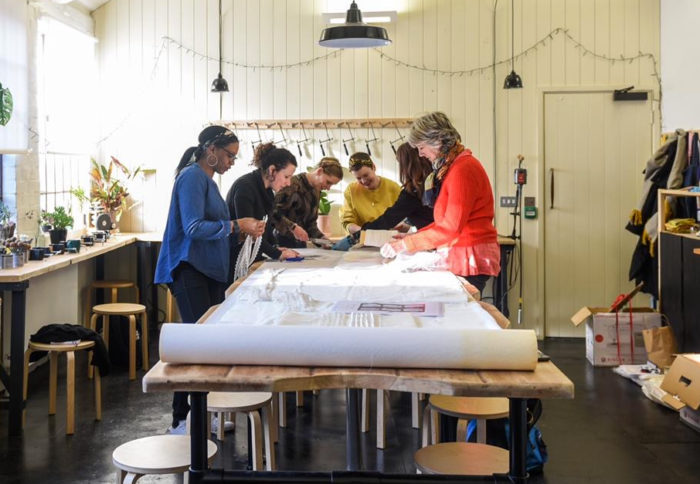 Volunteers work on a shroud