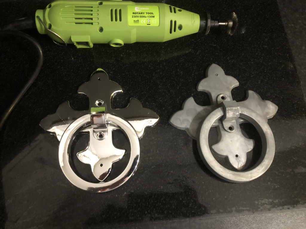 A shiny metal handle on the left, a matt on the right, green power tool to the top of image